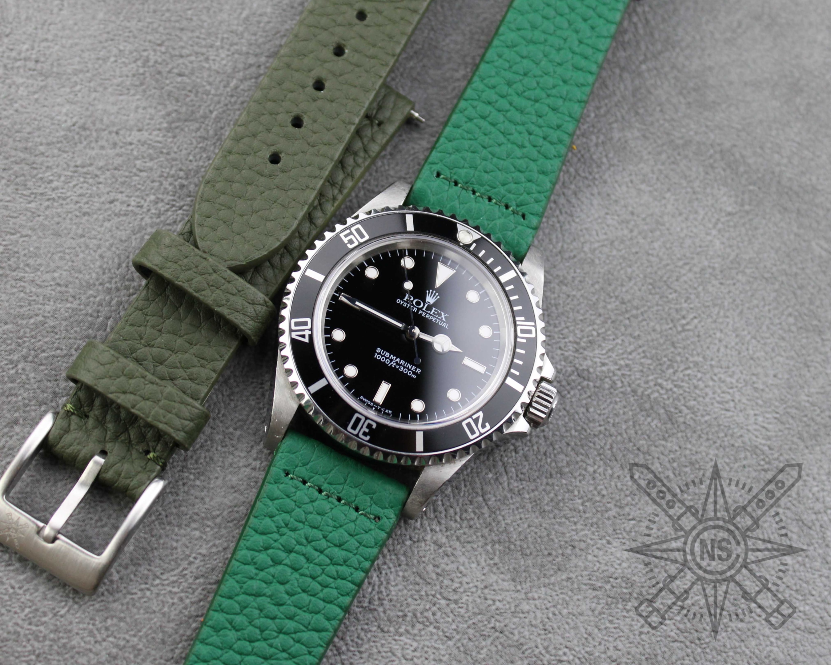 A close-up of a green leather watch strap showcasing its texture.