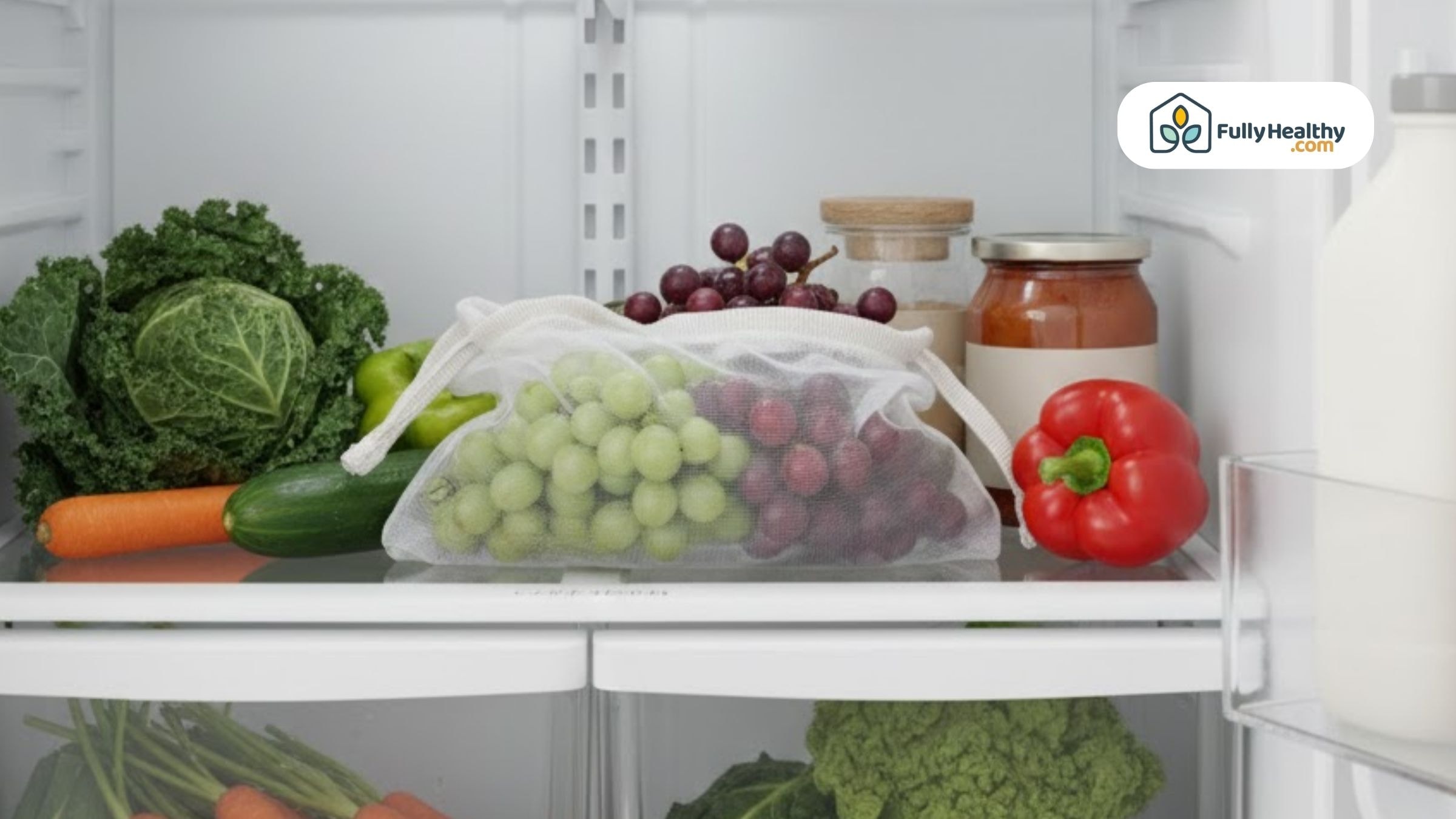 Grapes stored in a breathable produce bag inside the fridge with fresh vegetables.