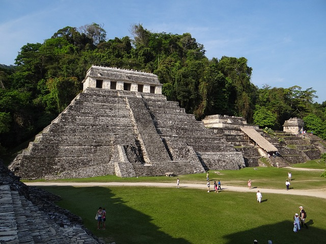 Tourists roam around Mayan ruins