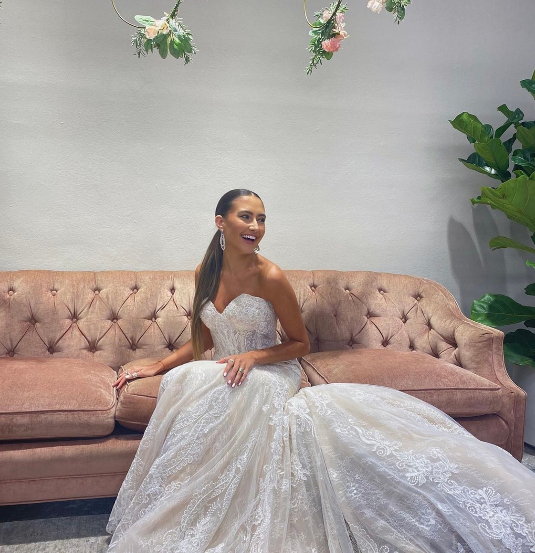  A bride wearing a white A-line wedding dress with a flowy skirt and fitted bodice