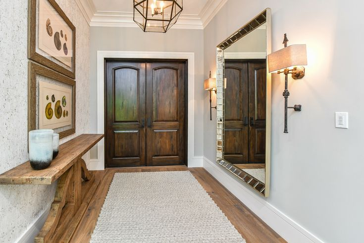 Stunning entryway featuring wooden floors and natural accents