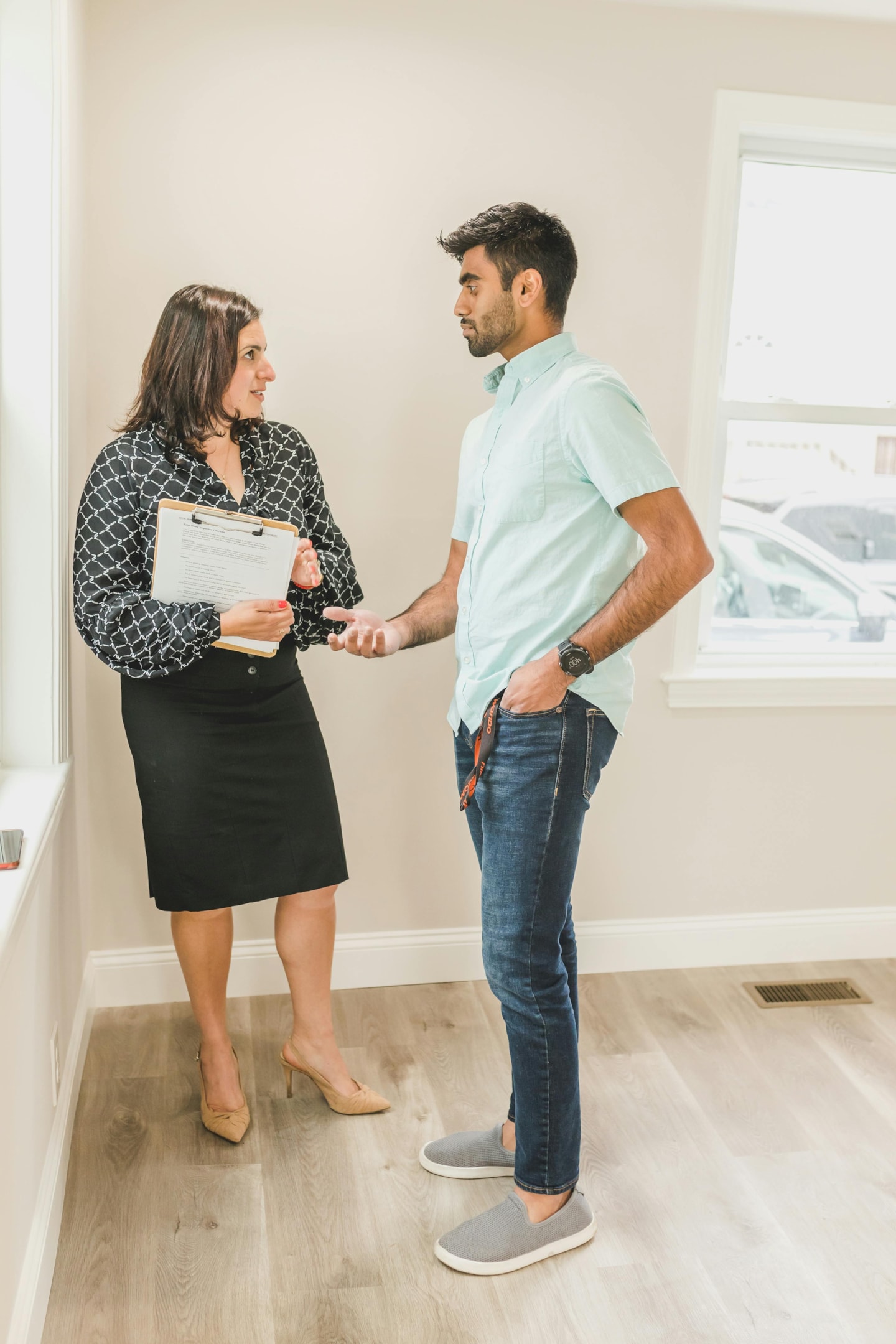 Real estate wholesaler walks through home with home seller.