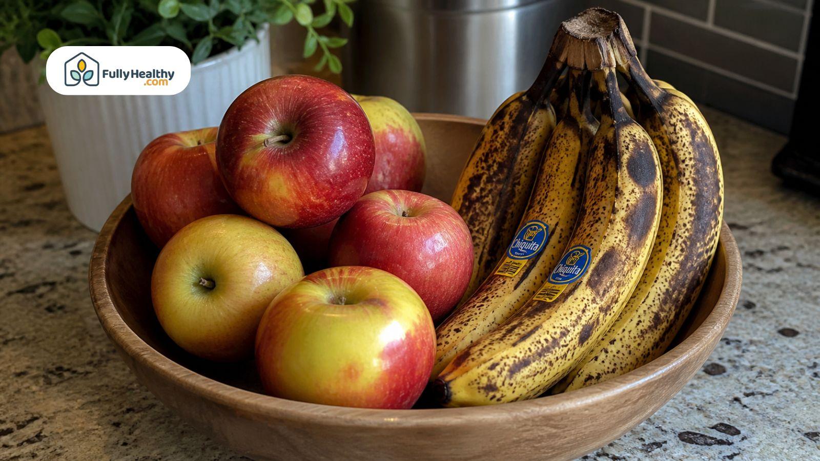 Apples stored next to overripe bananas in a fruit bowl showing faster ripening effect.
