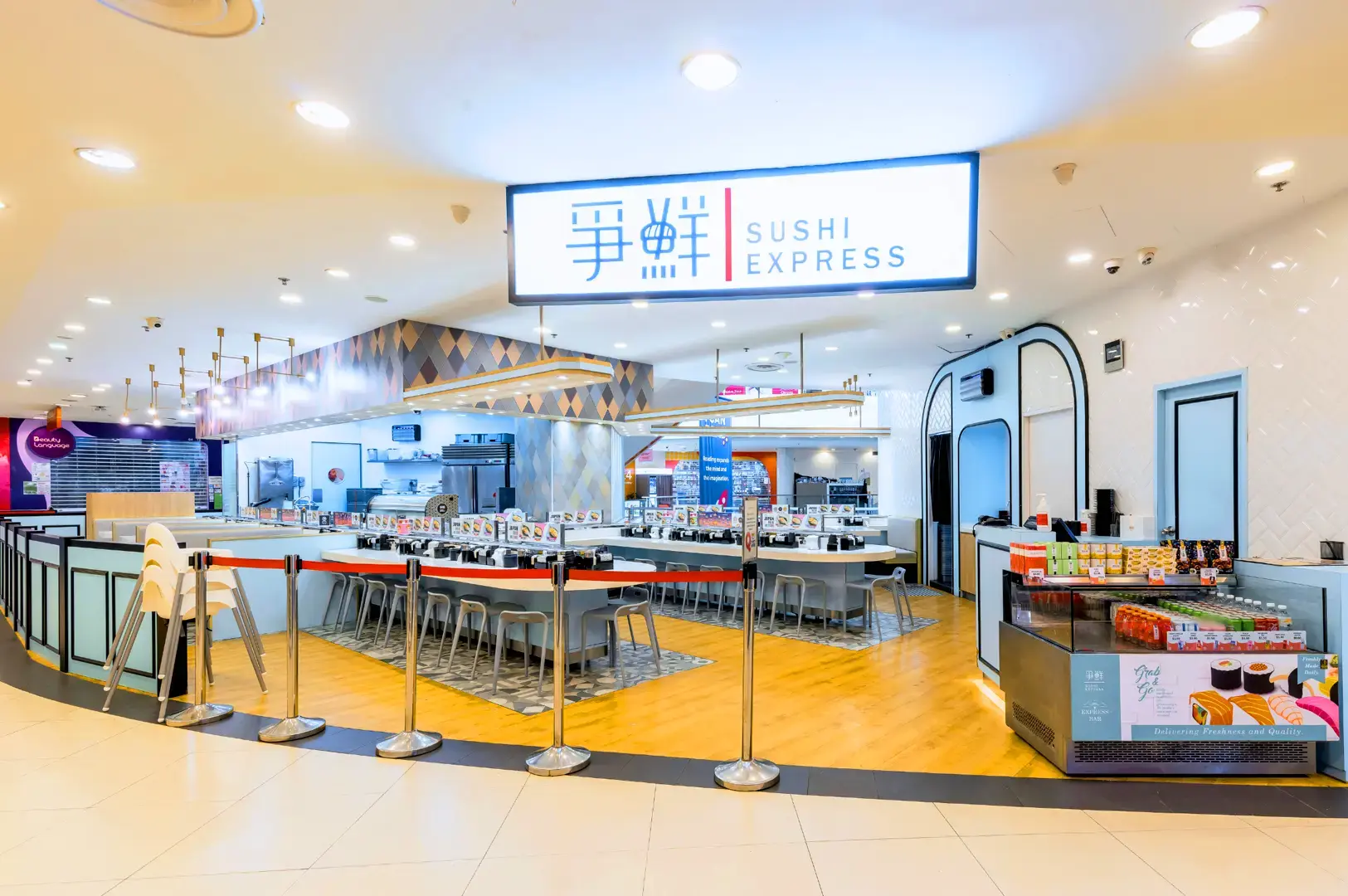 Sushi Express Singapore restaurant interior with conveyor belt sushi counter, dining booths and bright Japanese-inspired décor