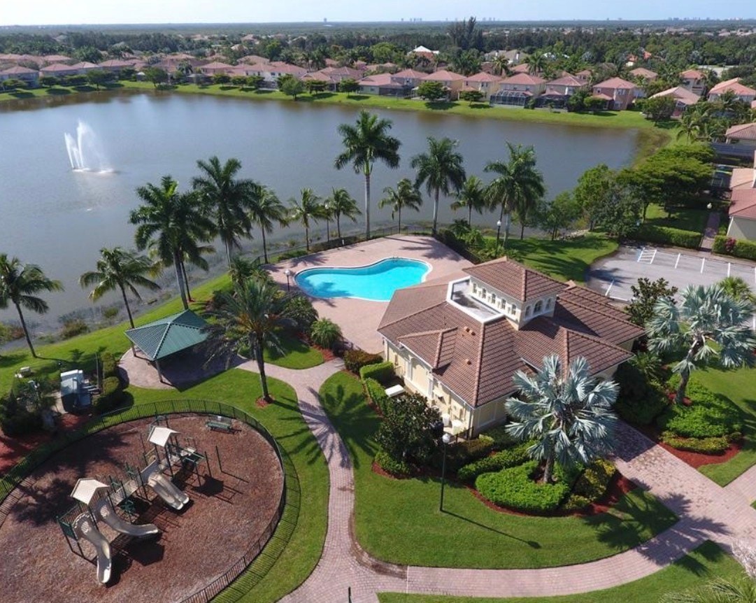 The image depicts a luxurious resort-style swimming pool area, complete with a spacious clubhouse and inviting cabana facilities, perfect for relaxation and social gatherings in Catalina Isles, Fort Myers. This vibrant setting highlights the appeal of homes for sale in this sought-after community.