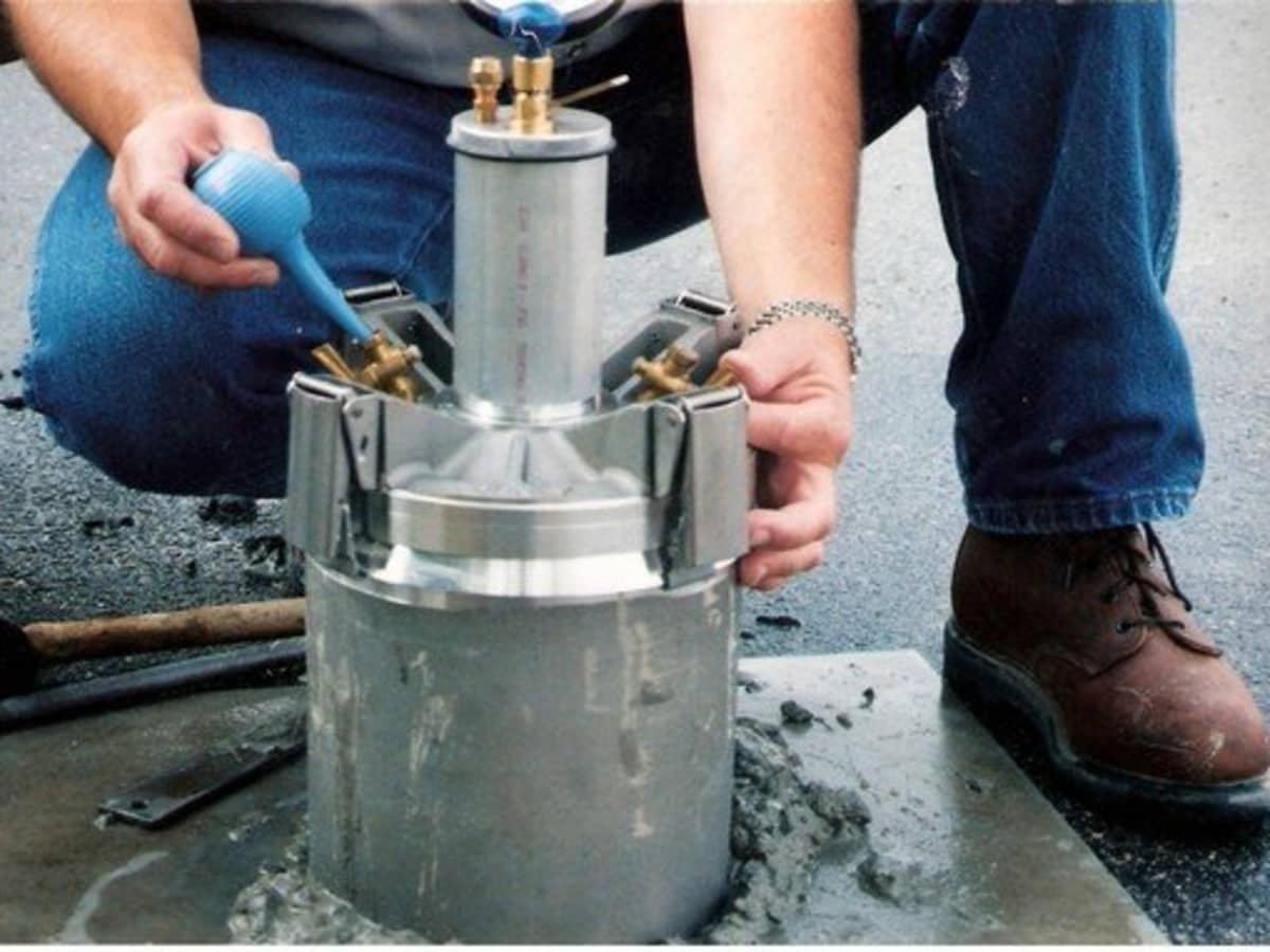 A technician measuring the air content of a freshly mixed concrete sample