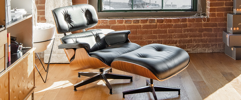 An iconic piece of mid-century modern furniture, the Eames lounge chair and ottoman set is made from moulded plywood and leather for comfort and timeless style.