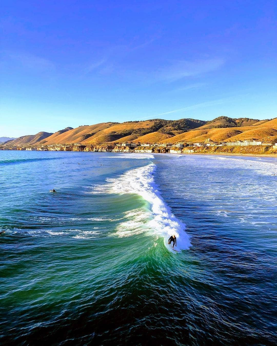 Surfing wave in Pismo Beach, California
