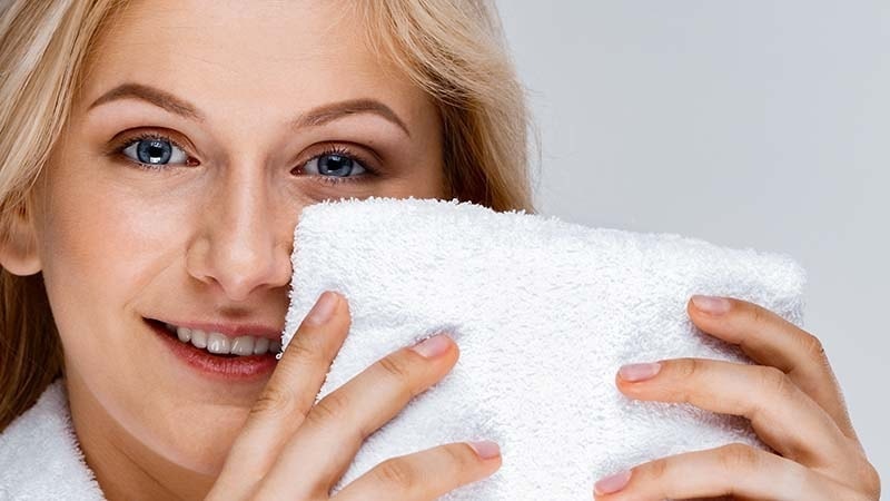 A woman using a white Face towel