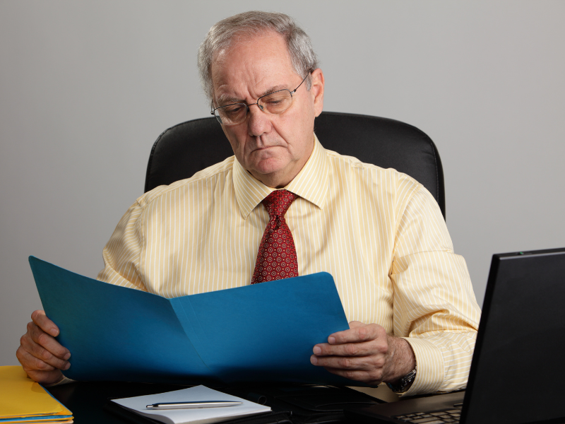 Image of a person reading a report.