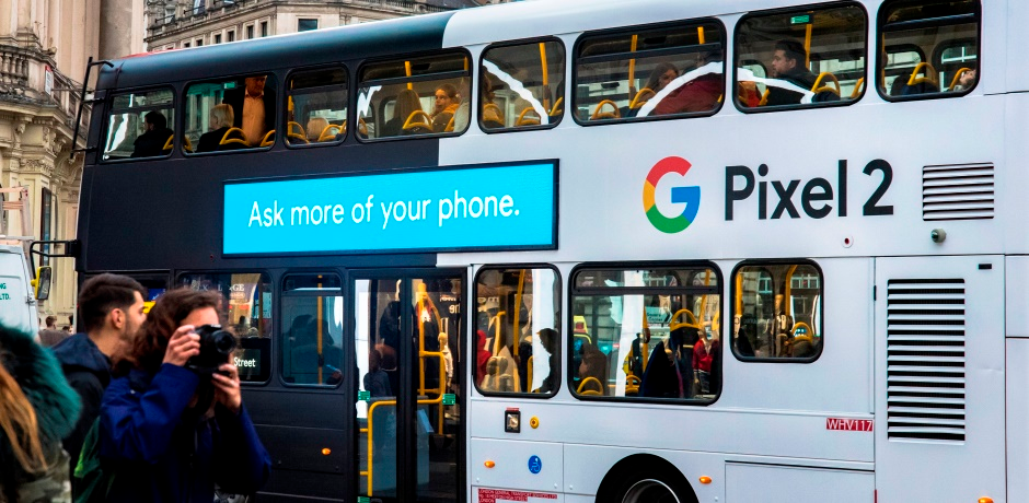 A bus wrapped in Google's branding. 