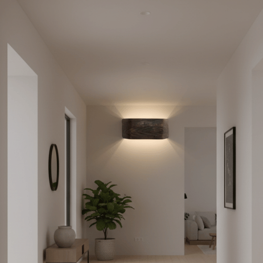 Industrial wall lighting with a rectangular metal fixture casting ambient light in a hallway.