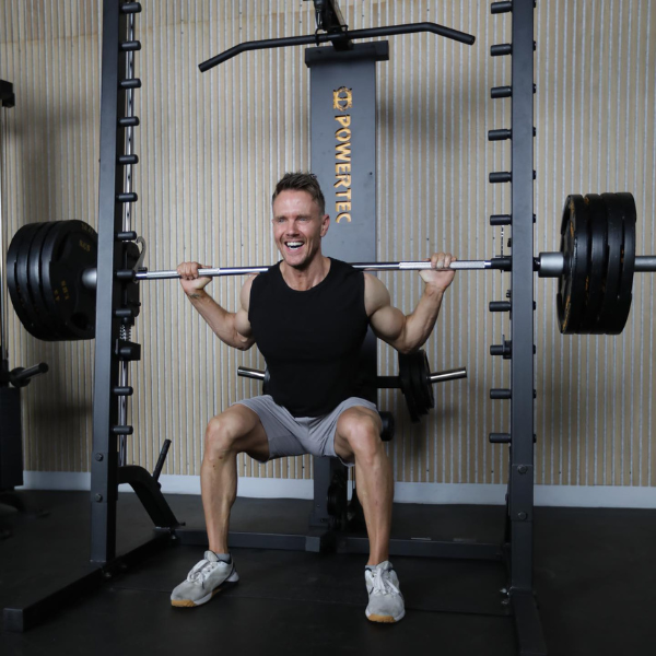 An image showing a person performing a Smith machine squat with proper form.