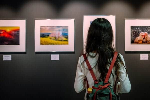 girl with black looking at artwork in a Welsh art gallery