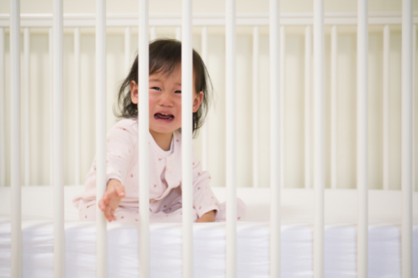 Crying baby in crib