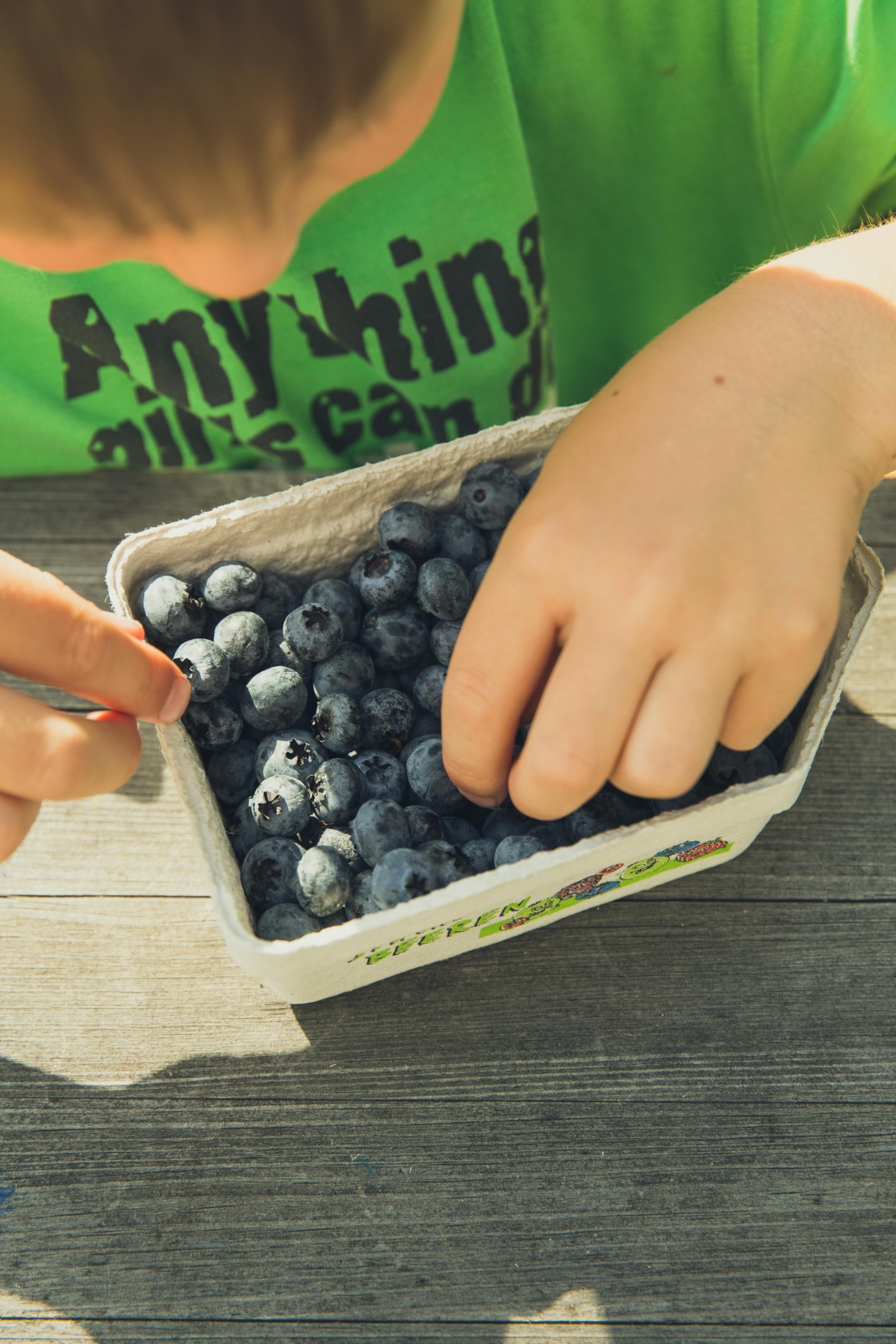 A picture showing child happily eating nutritious food, promoting positive eating habits.