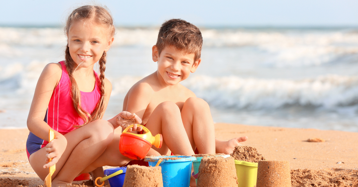 Two children building sandcastles and playing in the sand at a family-friendly Jersey Shore beach in Lavallette NJ