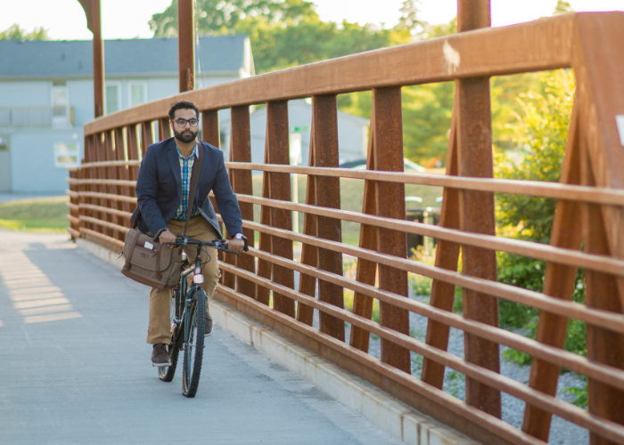 A mountain bike rider commuting to work on a paved road