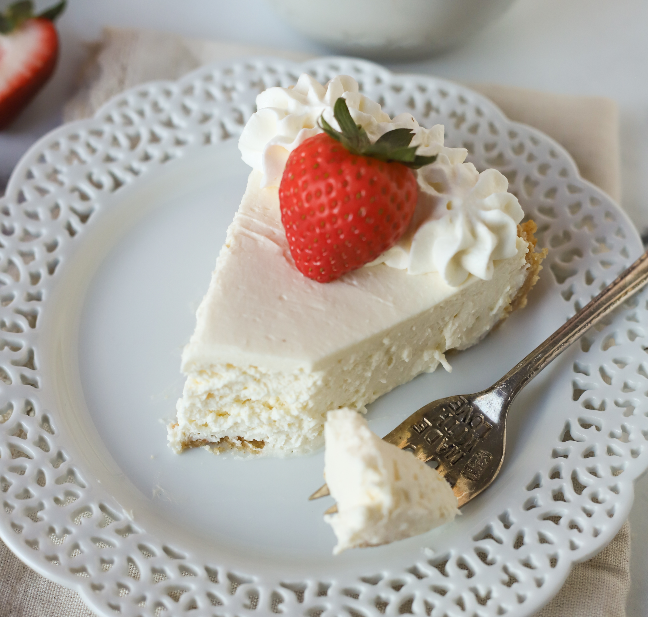slice of no bake cheesecake on a plate with a fork