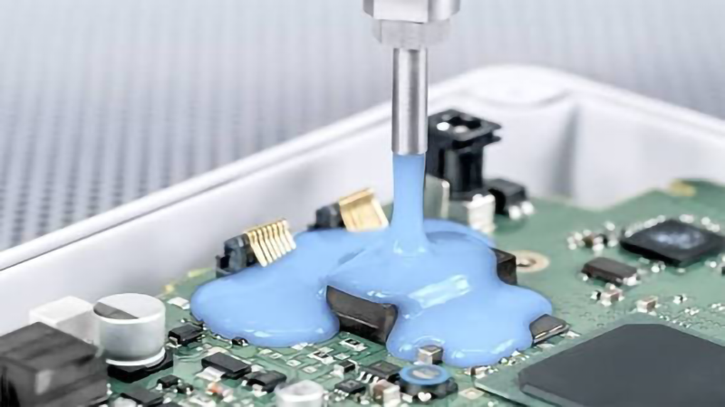 Blue thermally conductive potting compound is used to pot the motherboard.