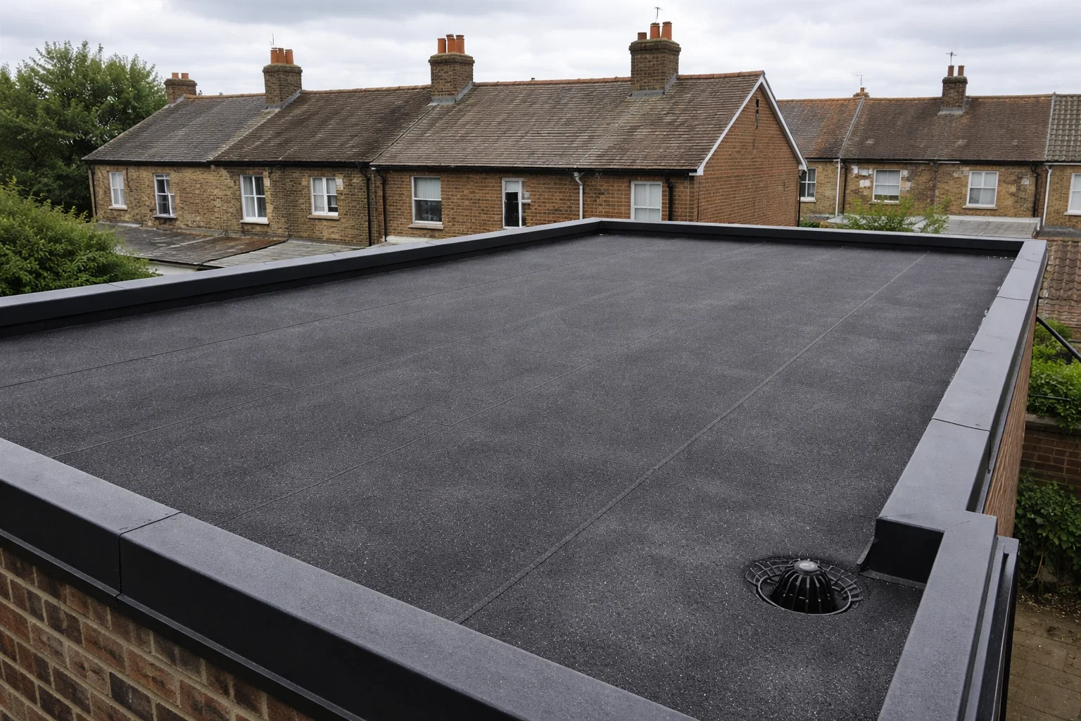 Felt flat roof on a UK residential property showing typical wear after years of exposure to British weather.