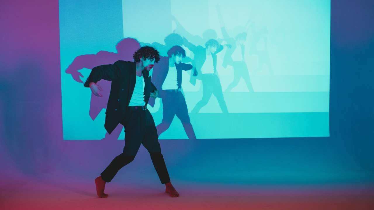 a person dancing in front of a LED screen
