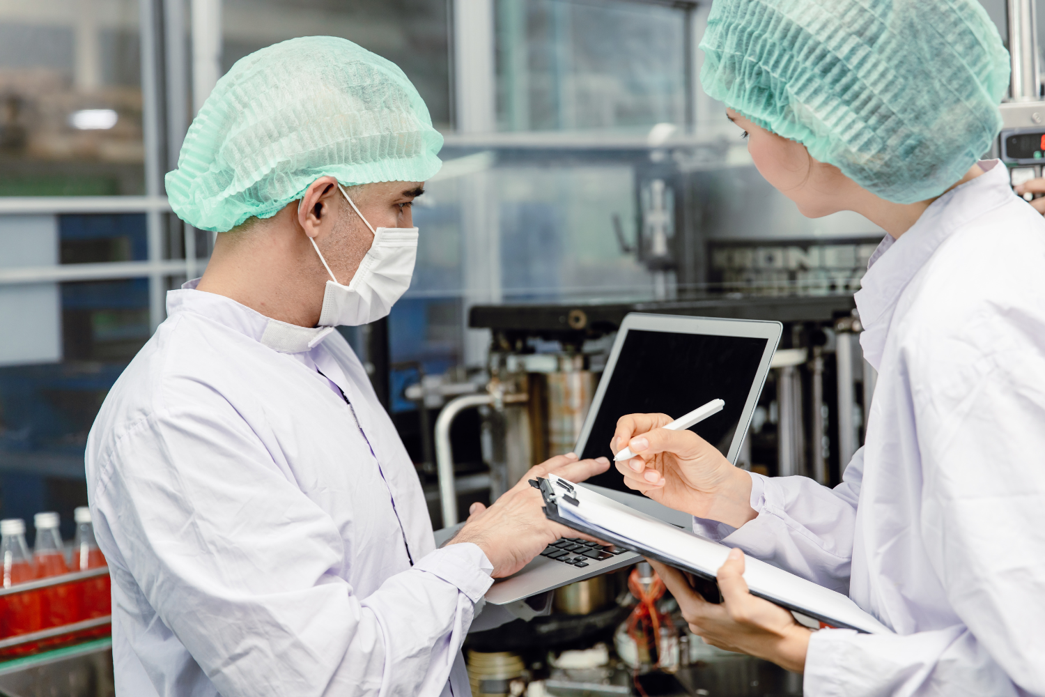 Two facility workers in PPE.