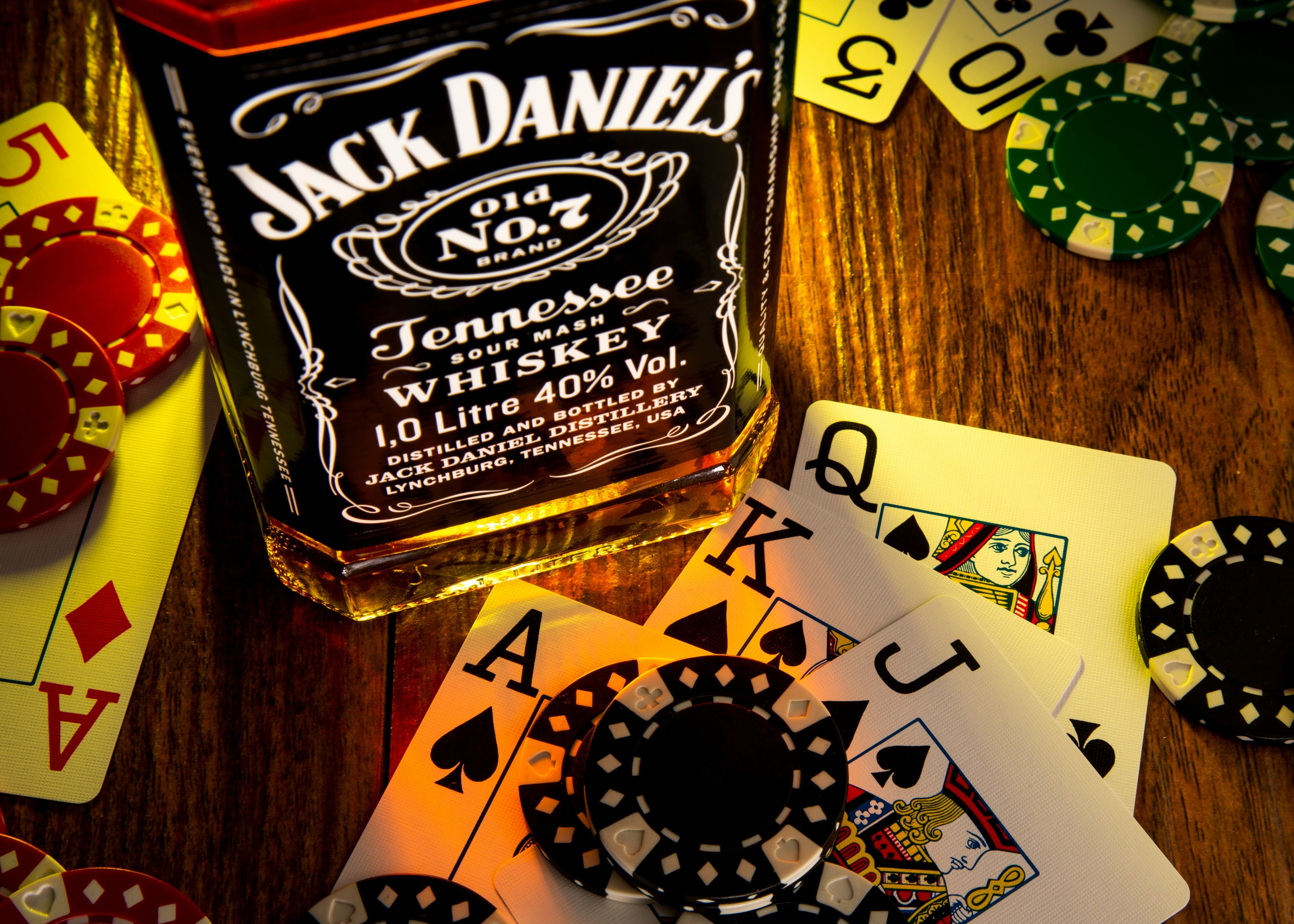 playing cards with a bottle of liquor