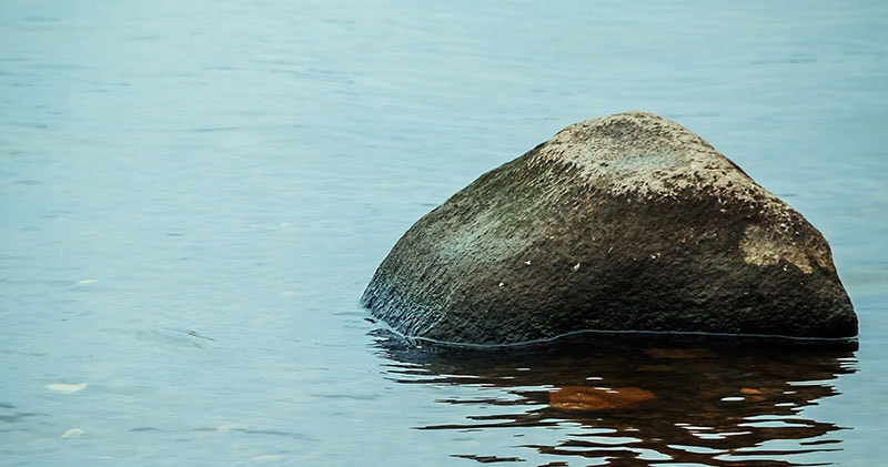 A rock positioned on the right, representing the stillness of the soul.