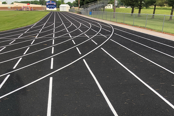 Freshly restriped running track at I-35 High School in Truro, IA, featuring updated exchange zones and precise lane markings to enhance athlete performance and safety.
