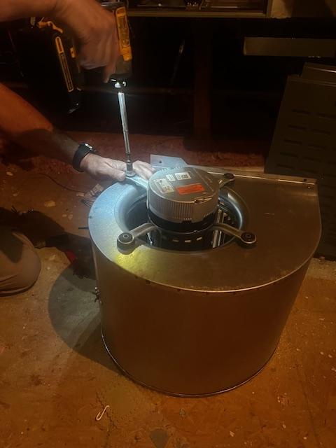 Technician removing blower motor during HVAC repair in McKinney, Texas