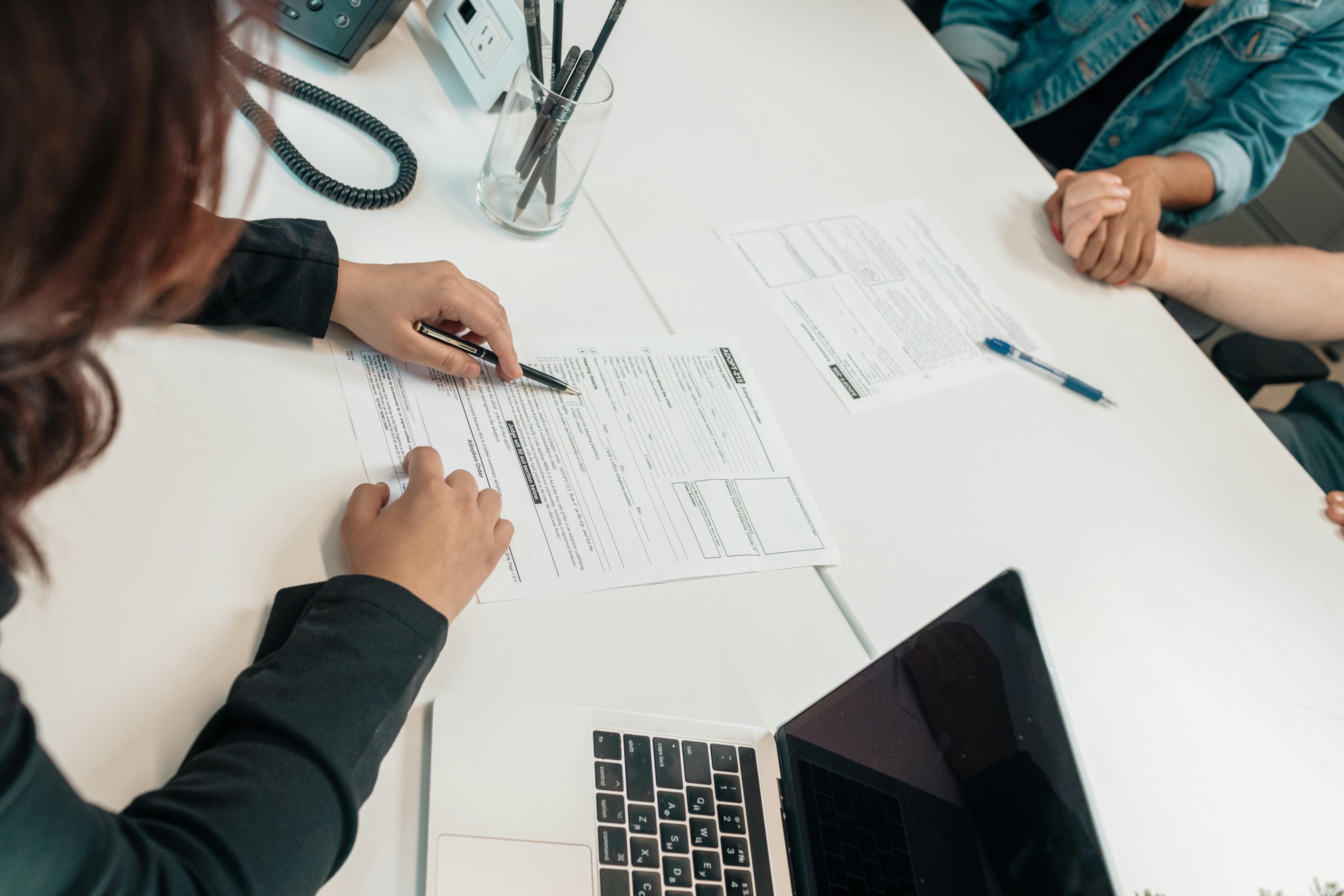 Banker reviews terms of loan contract with real estate investors.