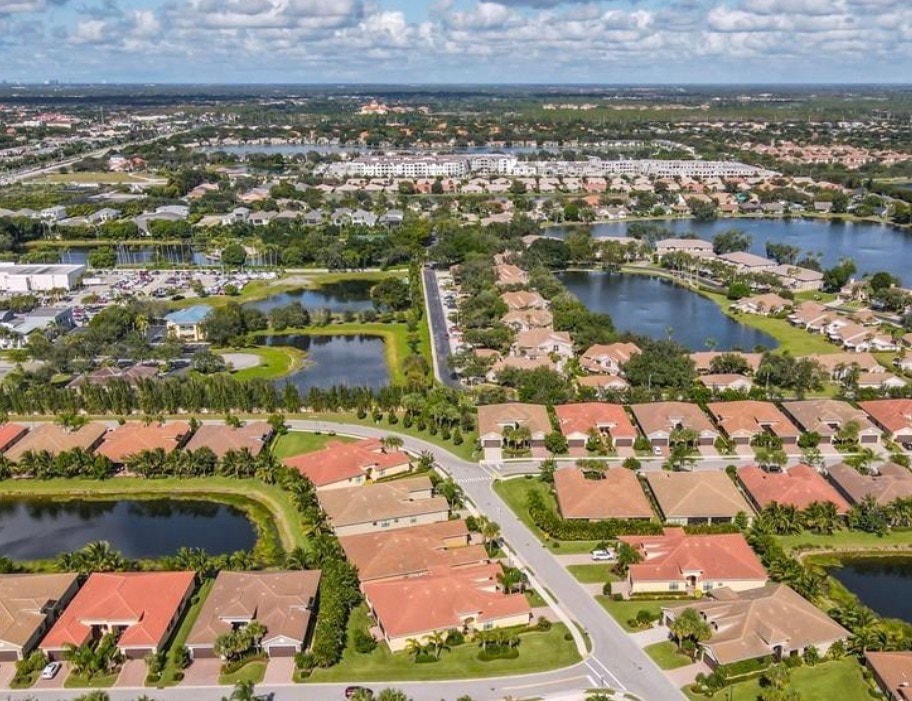 The image showcases well-maintained tennis and pickleball courts, illuminated by professional lighting, with comfortable seating areas nearby for spectators. This vibrant sports facility is part of the luxurious Marbella Isles community, offering residents an active lifestyle in a stunning resort-style environment.