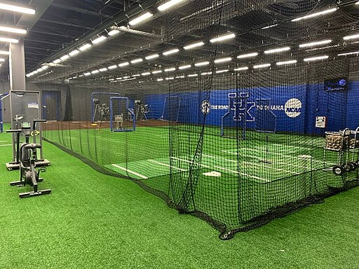 An image of one of the best batting cages for home use being maintained during routine maintenance.