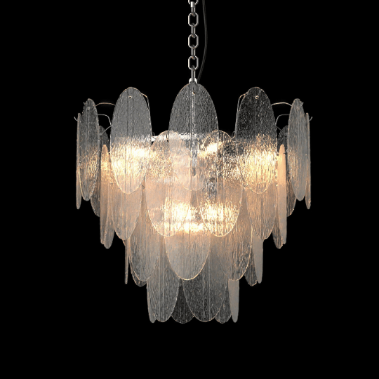 Elegant chandelier with overlapping transparent glass discs, emitting a soft warm glow, suspended from a chain against a black background.