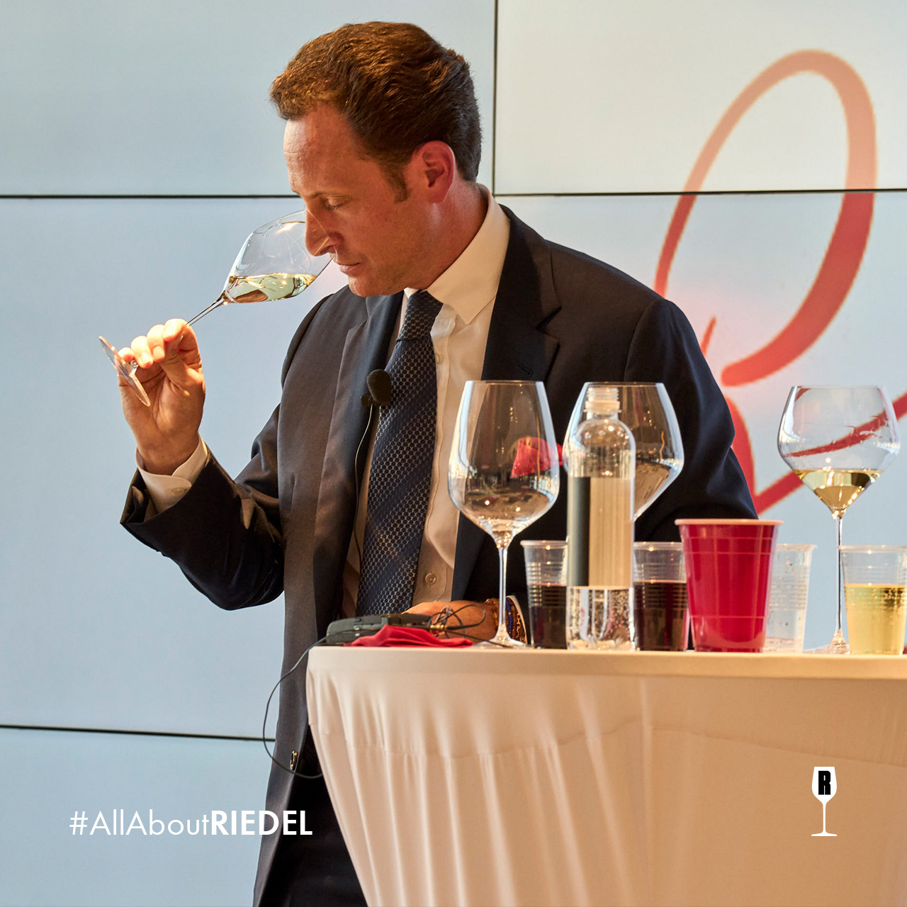 Man testing the nose of a white wine