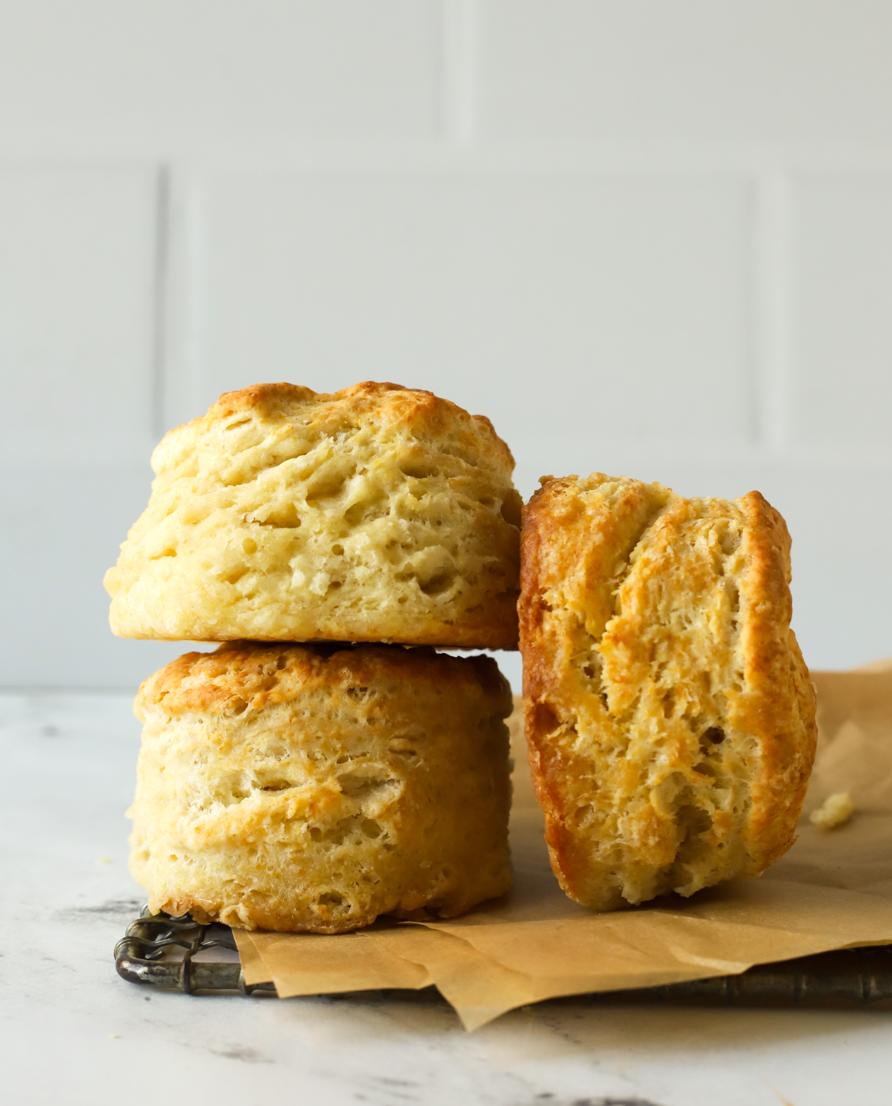 three flaky biscuits on a wire rack