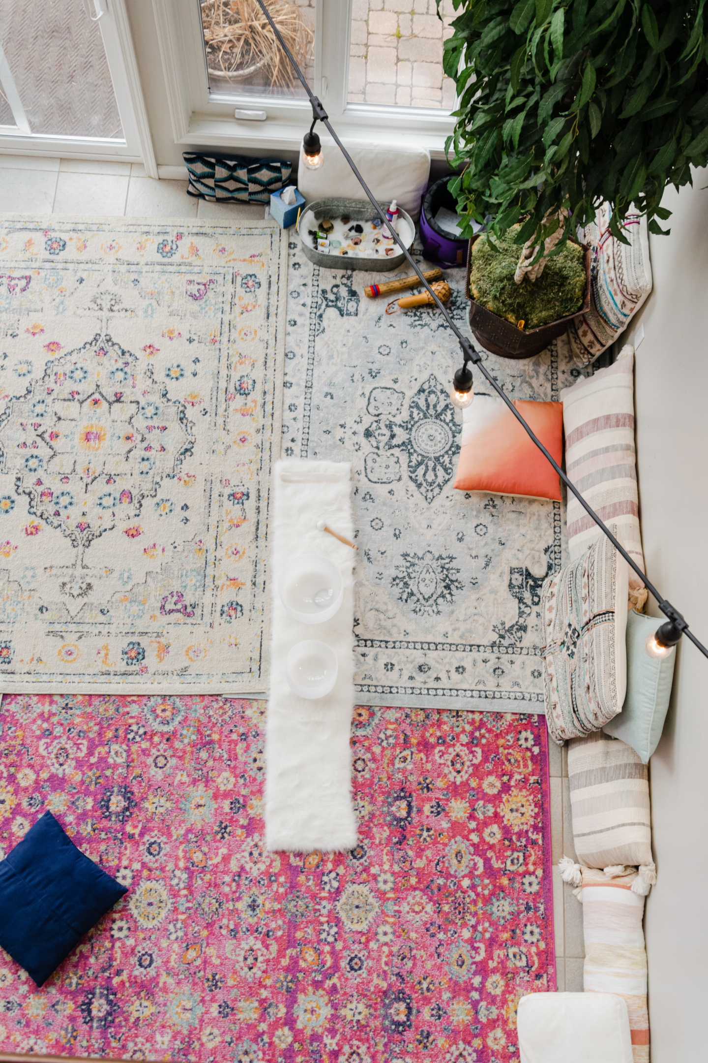 birds eye view of a meditation space with pillows carpet and plant