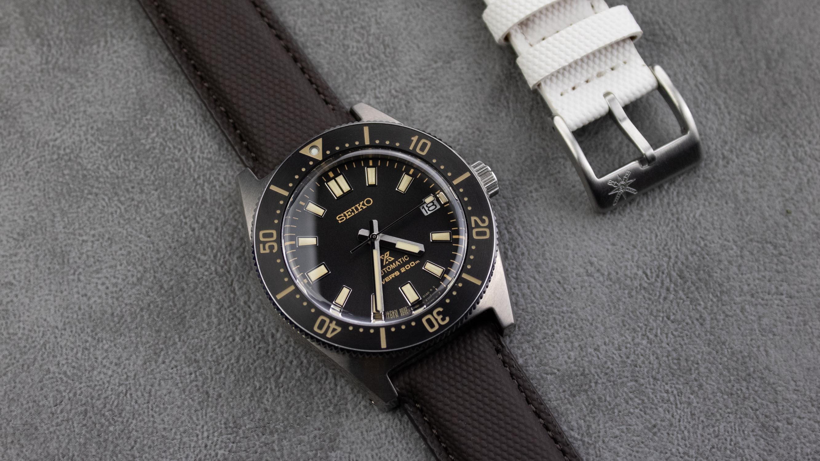 A stylish grey sailcloth watch strap displayed on a wooden surface.