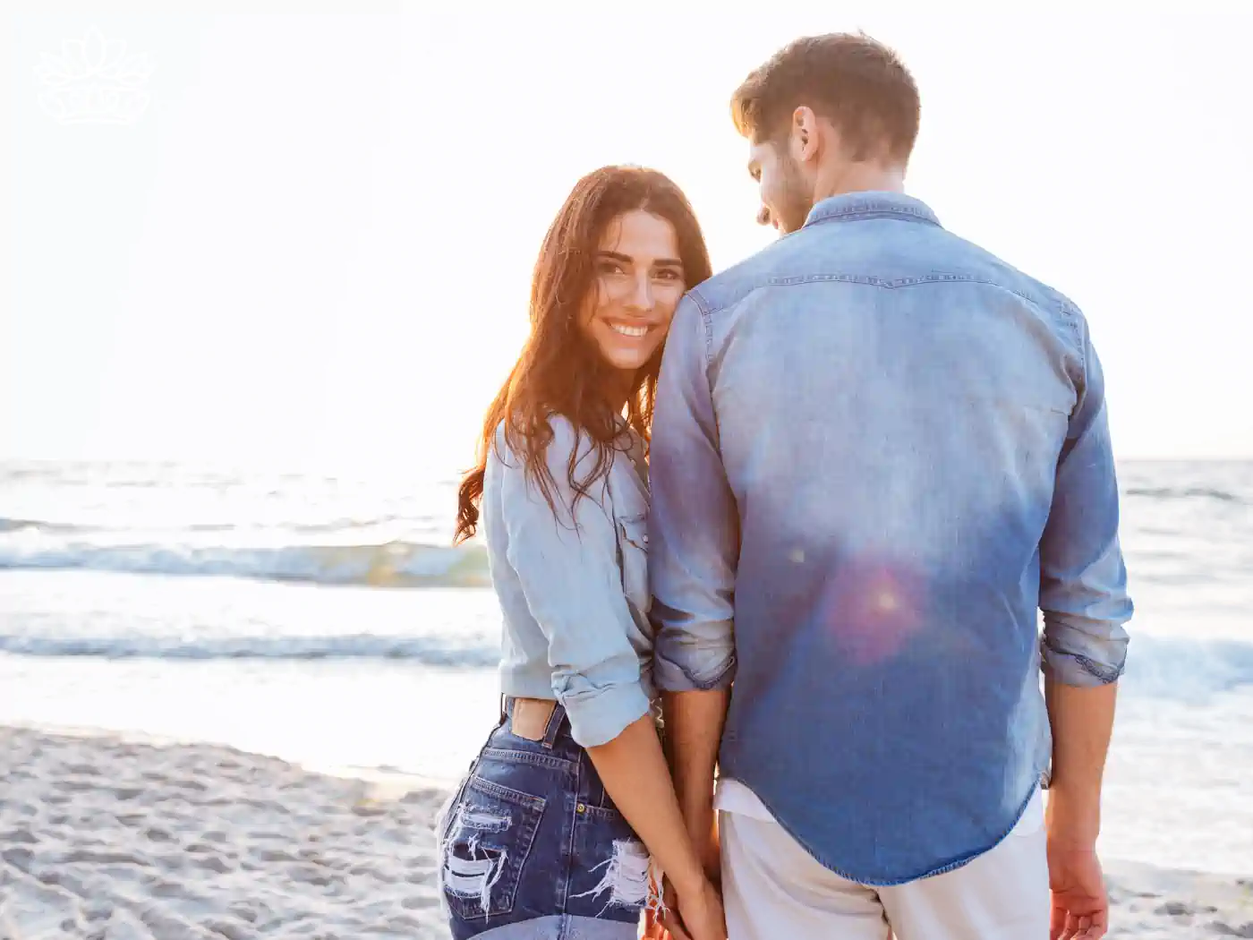 A couple holding hands on a beach, enjoying a serene and romantic moment - Fabulous Flowers and Gifts, Heartfelt Moments Collection.