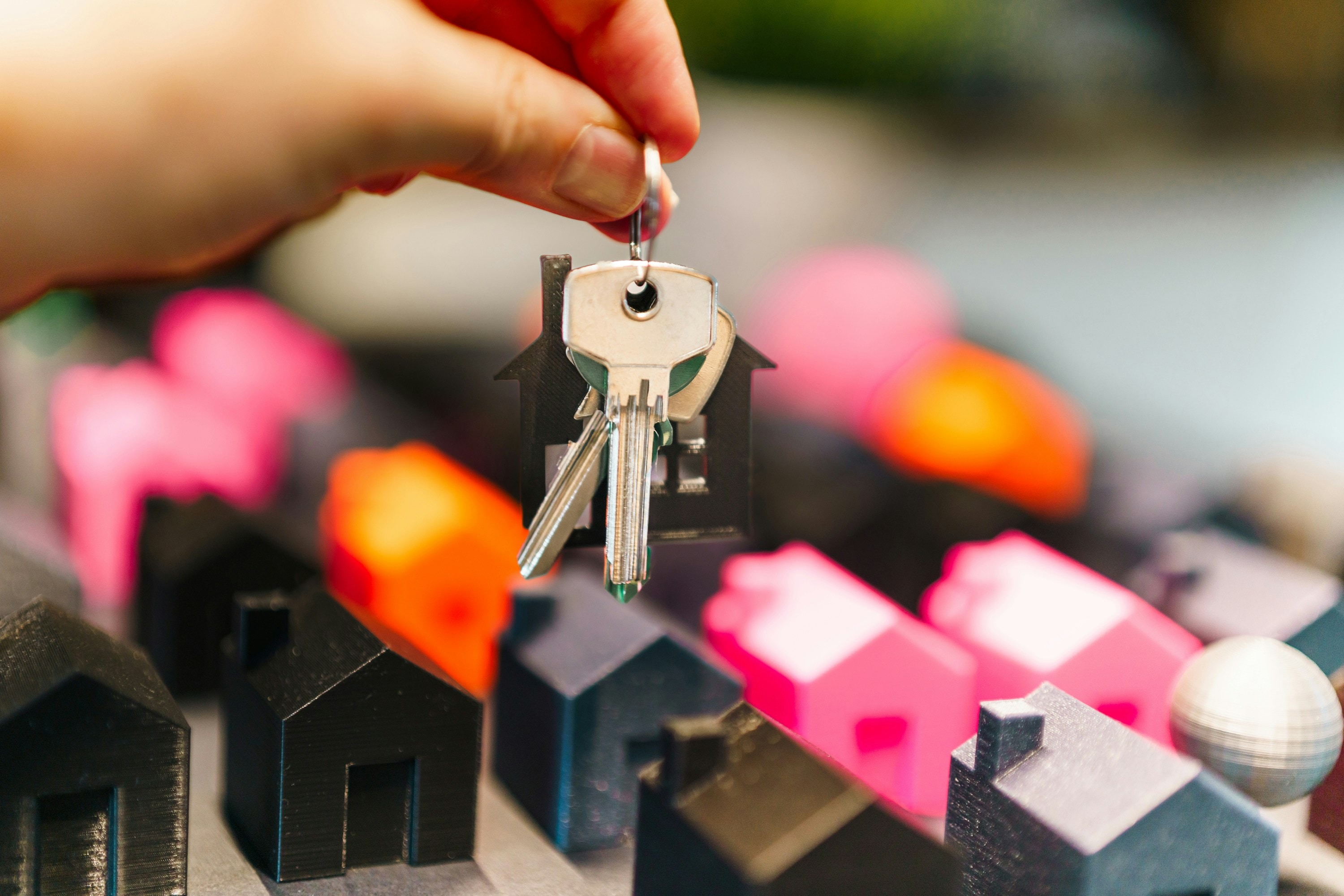 House keys being held by real estate investor after successful house purchase.