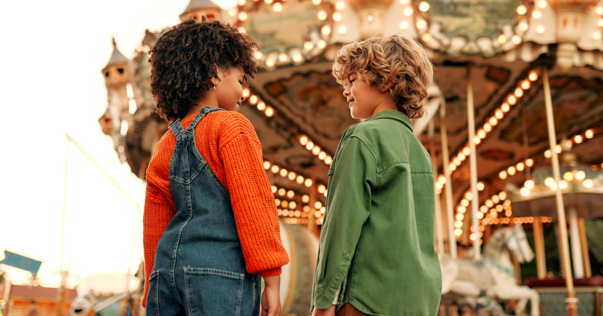 Kids enjoying a carnival ride, symbolizing the fun yet chaotic nature of ADHD in love and marital relationships, capturing the non-ADHD partner's perspective.