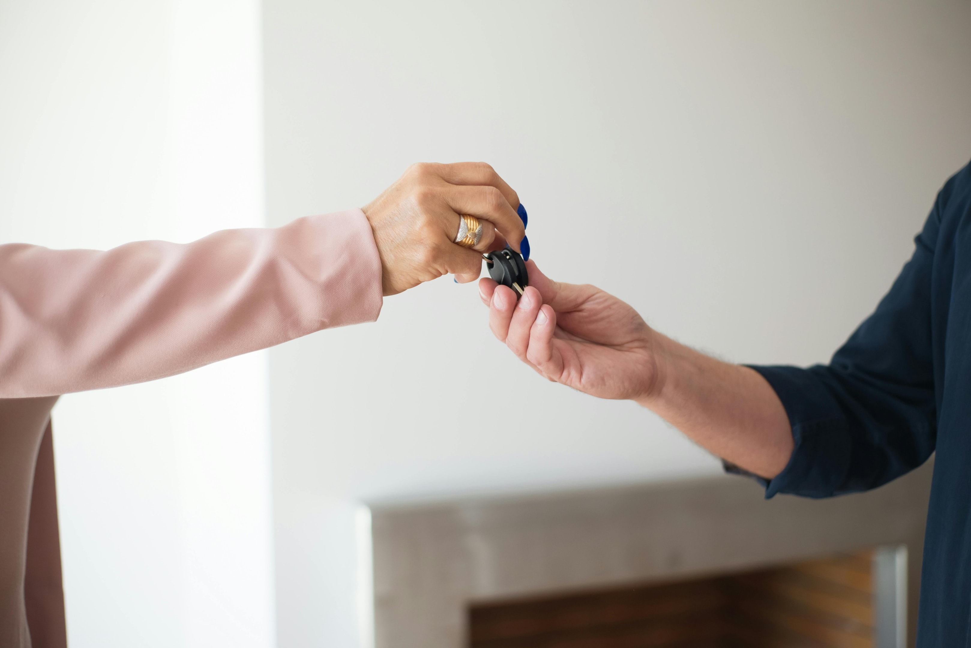 Keys passed from motivated seller to property investor.