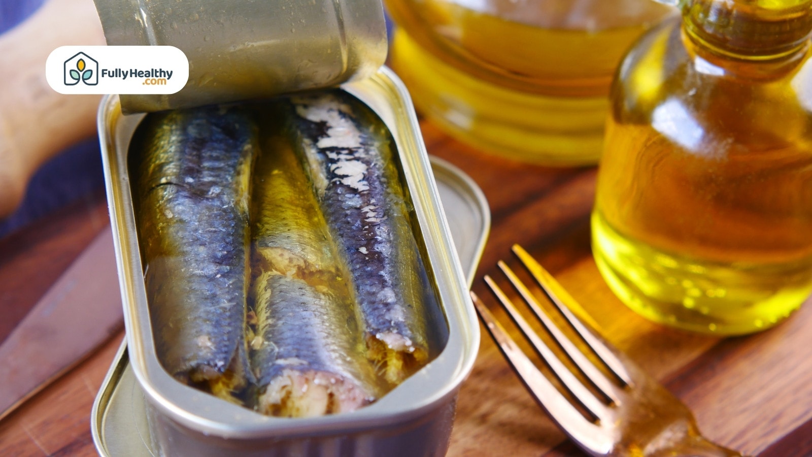 Open canned sardines in oil with fork and bottles nearby
