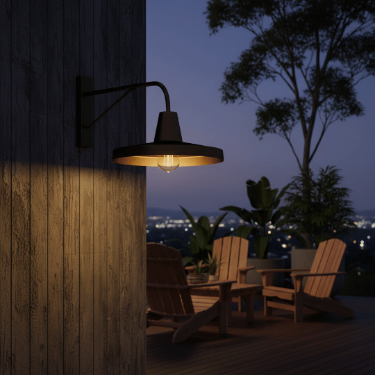 Outdoor patio wall featuring a barn light fixture, casting warm light over a cozy seating area with a city skyline backdrop at night.