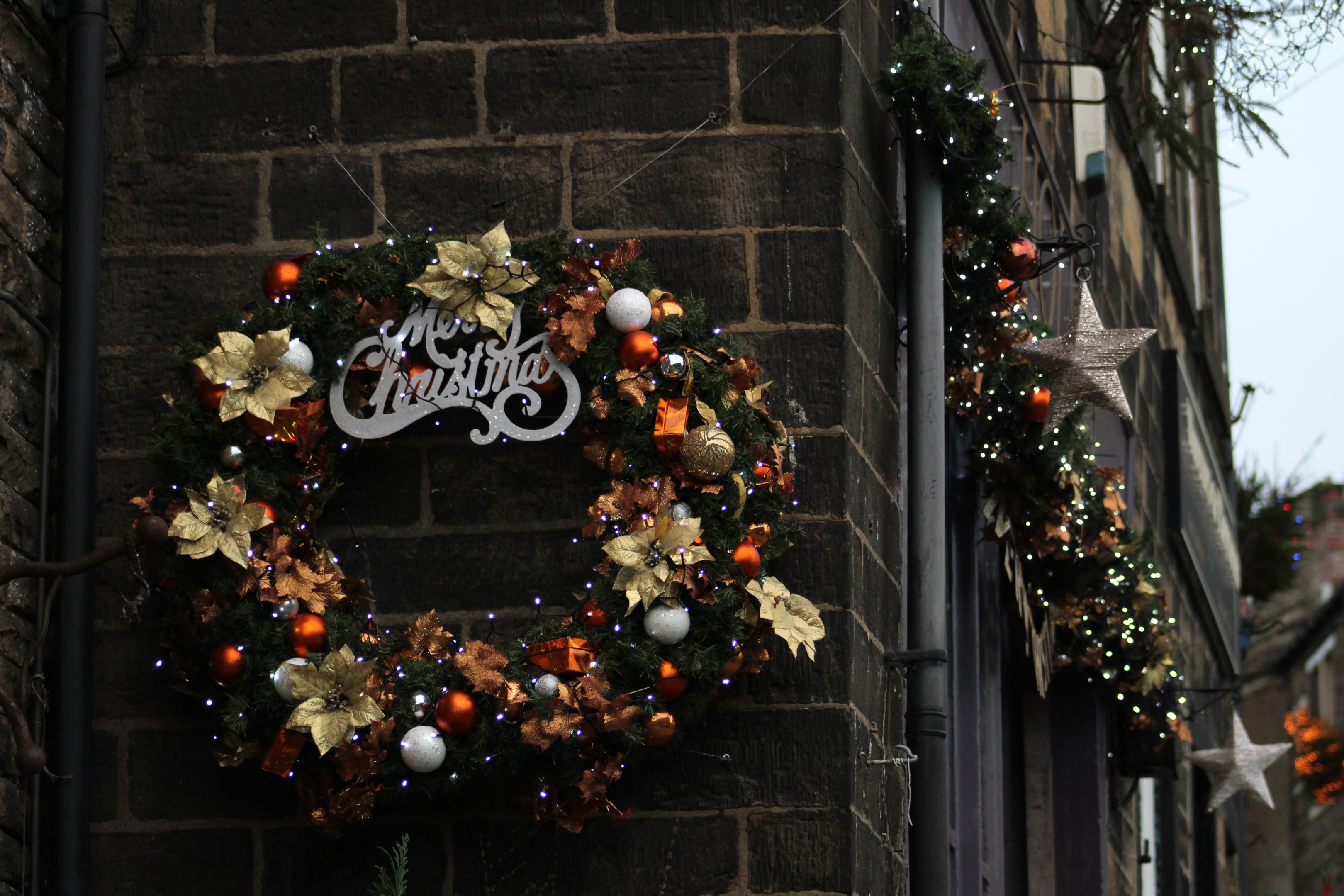 traditional wreath hanging on door of new home for Christmas 