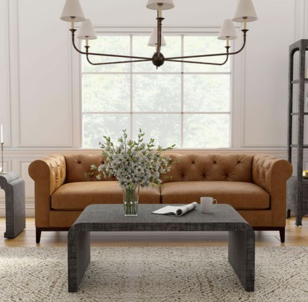 charcoal waterfall coffee table in front of tan sofa