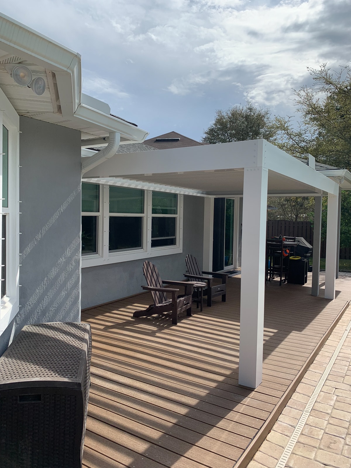 white pergola installed on deck giving a covered patio feel