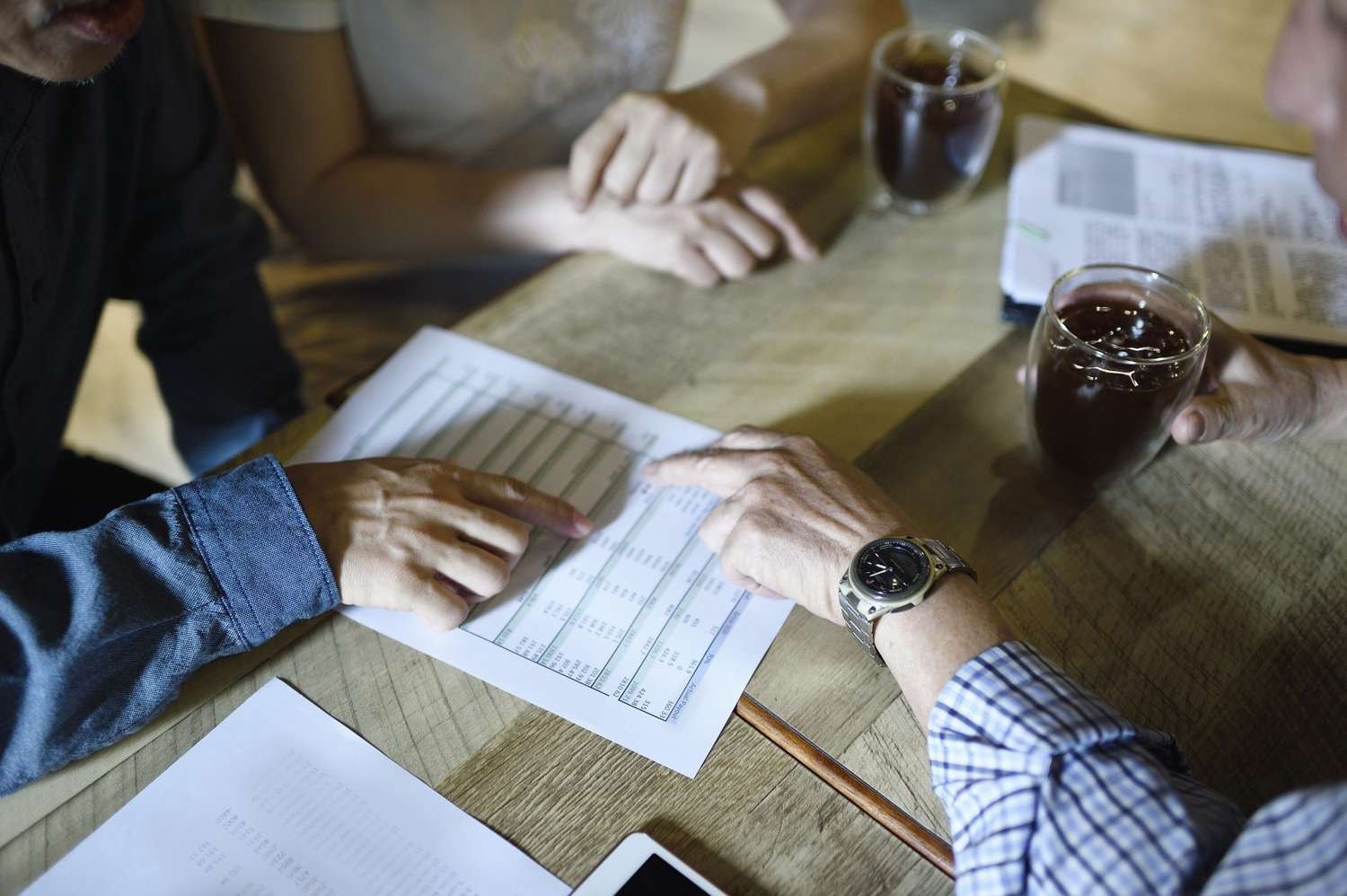 Business owner smiling at a desk with a shield icon representing small business insurance protection