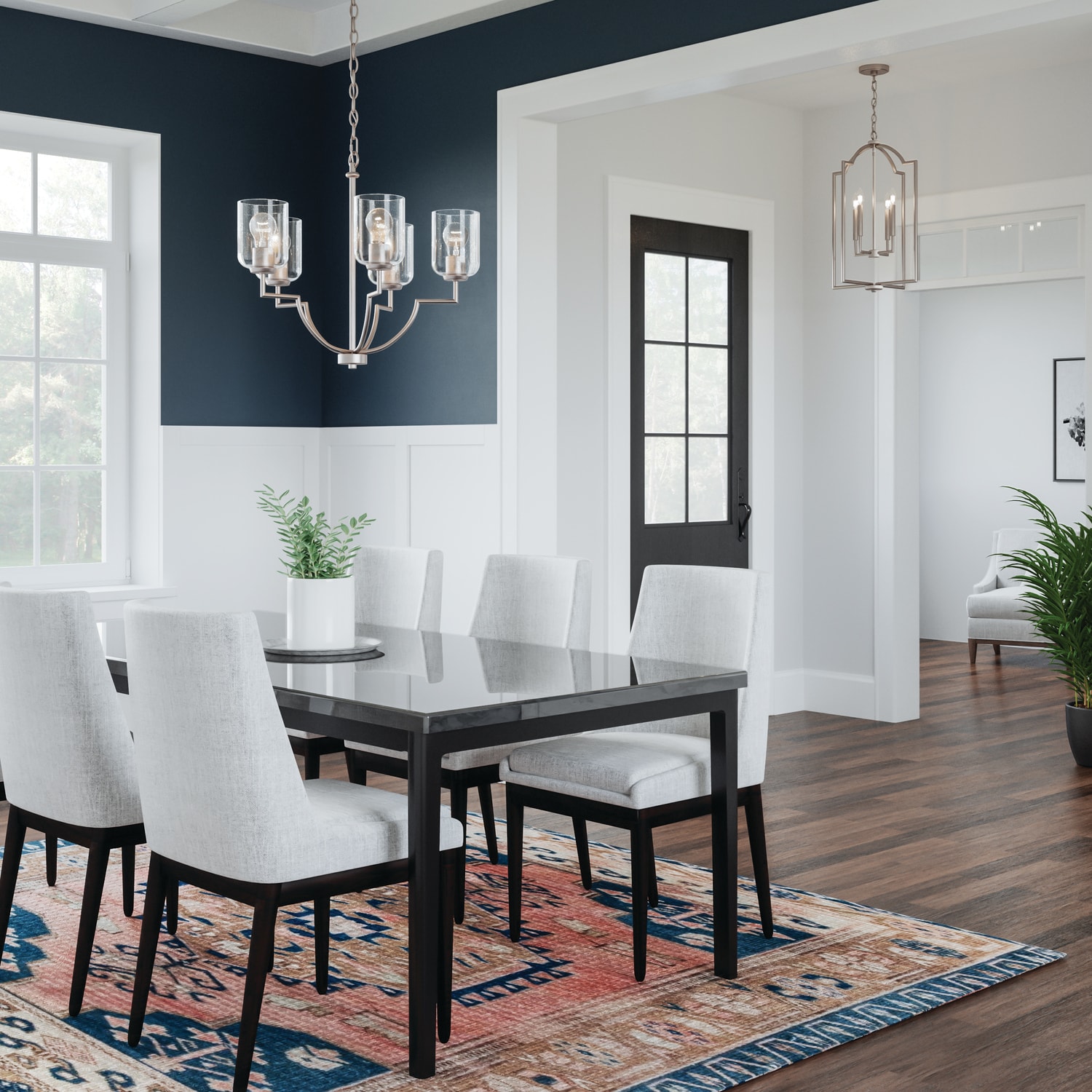 Elegant dining room with a Carter 5-Light Chandelier over a modern glass table, featuring a stylish mix of contemporary design and classic charm.